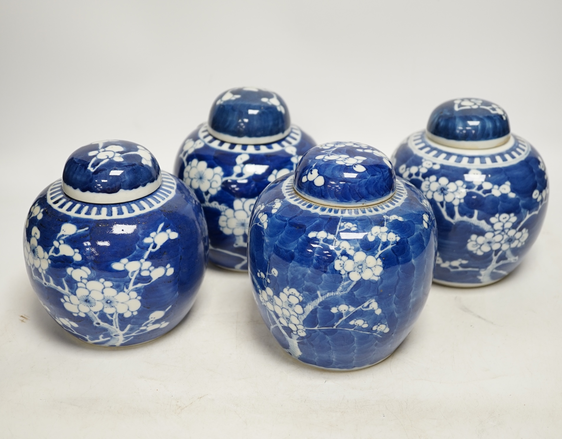 Four Chinese blue and white prunus jars and covers, tallest 15cm high. Condition - good